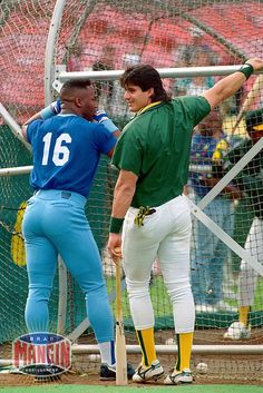 two baseball players standing next to each other