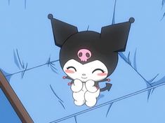 a cartoon character sitting on top of a bed