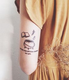 a woman's arm with a tattoo on it that has an image of a coffee pot