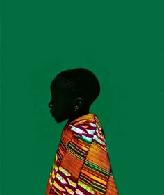 a woman in an orange and green dress standing with her back turned to the camera