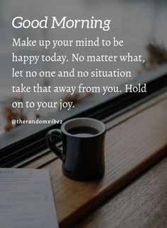 a cup of coffee sitting on top of a table next to a window sill