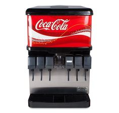 a coca cola machine sitting on top of a counter
