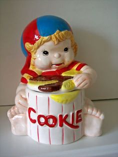 a ceramic figurine of a child eating cookies