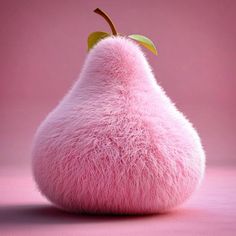 a pink pear shaped object with a leaf on top