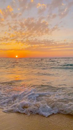 the sun is setting over the ocean with waves