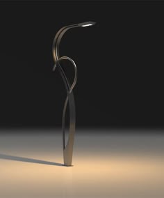 an abstract sculpture is shown in the middle of a dark room with light coming from it