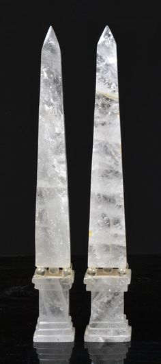 two white crystal obelisk standing on top of a table
