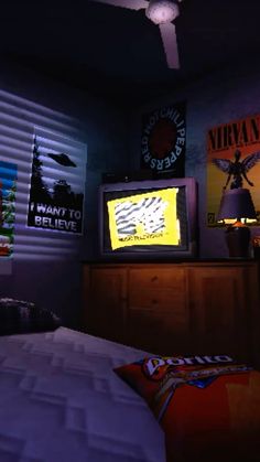 a bedroom with posters on the wall and a bed in front of a flat screen tv