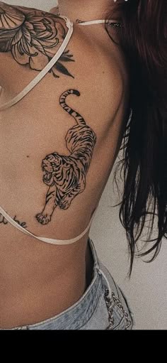 a woman with a tiger tattoo on her back