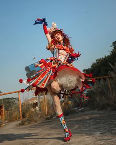 a woman dressed in red, white and blue is dancing