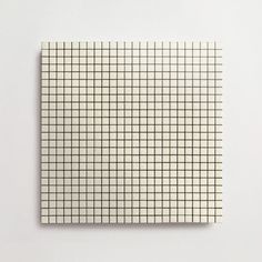 a piece of paper that is on top of a white surface with black and white squares