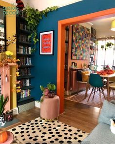 a living room filled with furniture and a fire place next to a dining room table