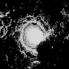 a black and white photo of a circular object in the middle of dark space with stars