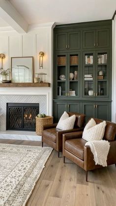 a living room filled with furniture and a fire place in front of a bookcase