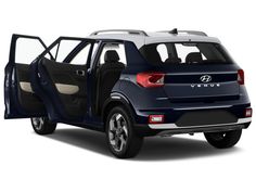 the back end of a blue car with its door open