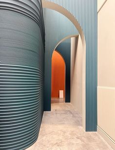 an arch in the middle of a building with blue and white stripes on it's walls