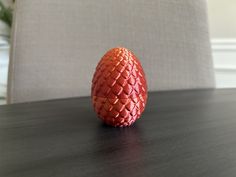 an orange egg sitting on top of a wooden table