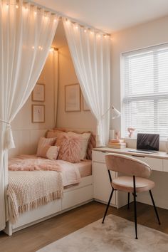 a bedroom with a bed, desk and window covered in white draping curtains
