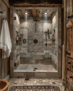 a walk in shower sitting inside of a bathroom next to a wooden cabinet and rug