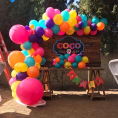 a birthday party with balloons and decorations on the side of the road in front of a sign that says coo coo