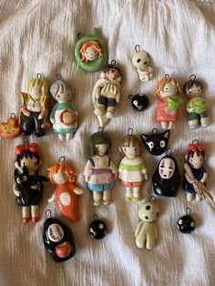 many small figurines are arranged on a white sheet