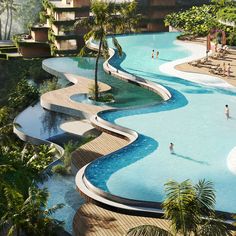 an outdoor swimming pool surrounded by palm trees and people on the water slide in the background