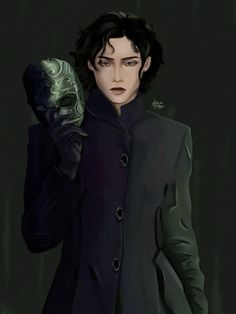 a man holding a green mask in his right hand and looking at the camera with an evil look on his face