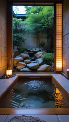 a japanese style garden is lit up by candles