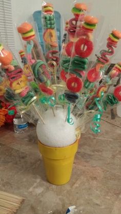 an ice cream cone filled with candies and donuts on top of a counter
