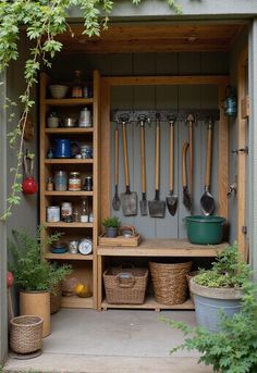 a garden shed with gardening tools and pots on the shelf, in front of it