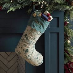 a christmas stocking hanging from the side of a fireplace
