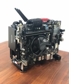 a computer motherboard sitting on top of a wooden table