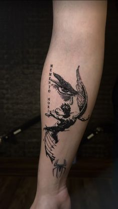 a tattoo on the leg of a person with a bird in it's hand