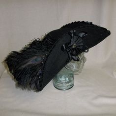 custom pirate hat | Deluxe Black Pirate Hat Tricorn with Black by RoyalHouseOfWhimsy Feathered Tricorn, Black Pirate Hat Design, Black Tricorn Hat, Pirate Tricorn Hat Halloween Costume, Tricorn Hat With Feathers, Pirate Hat With Feather, Adjustable Black Pirate Hat, Leather Pirate Tricorn Hat, Fancy Tricorn Hat