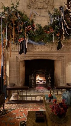 a living room filled with furniture and a fire place covered in christmas garlands next to a fireplace