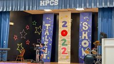 the stage is set up for an event with colorful banners and musical instruments on it