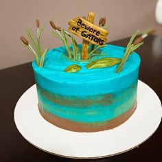 there is a blue cake with grass on top and a sign that says buddha of caffe