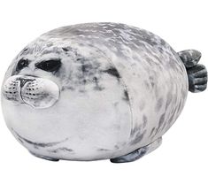 a stuffed seal animal sitting on top of a white surface