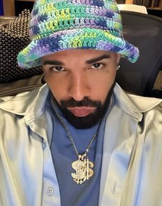 a man with a beard wearing a multicolored hat