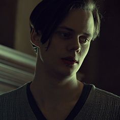 a young man is staring into the camera