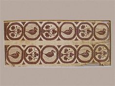 an old piece of cloth with designs on it