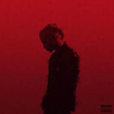 a man standing in front of a red background