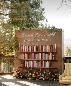 a chair and book shelf with books on it in front of a sign that says, every day is beautiful but ours is my favorite