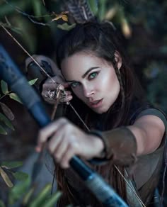 an image of a woman holding a bow and arrow in her hand, with the caption'top posts portraits vision follow '