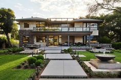 a large house with lots of windows and landscaping