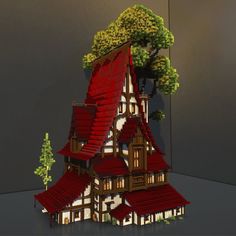 a house made out of legos with trees on the roof and red shingles