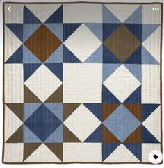 a blue, brown and white quilt with squares on the bottom is featured in an applique