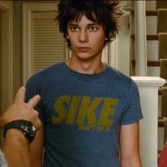 a young man giving the thumbs up sign