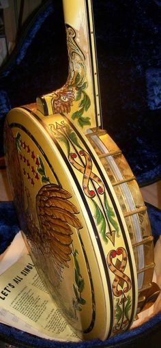 an elaborately decorated musical instrument sitting on top of a blue velvet covered tablecloth