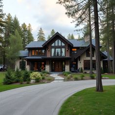 a large house with lots of windows in the front yard and trees on both sides